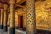 Luang Prabang, Laos - Wat Mai, the gilded stucco engravings of the veranda. 